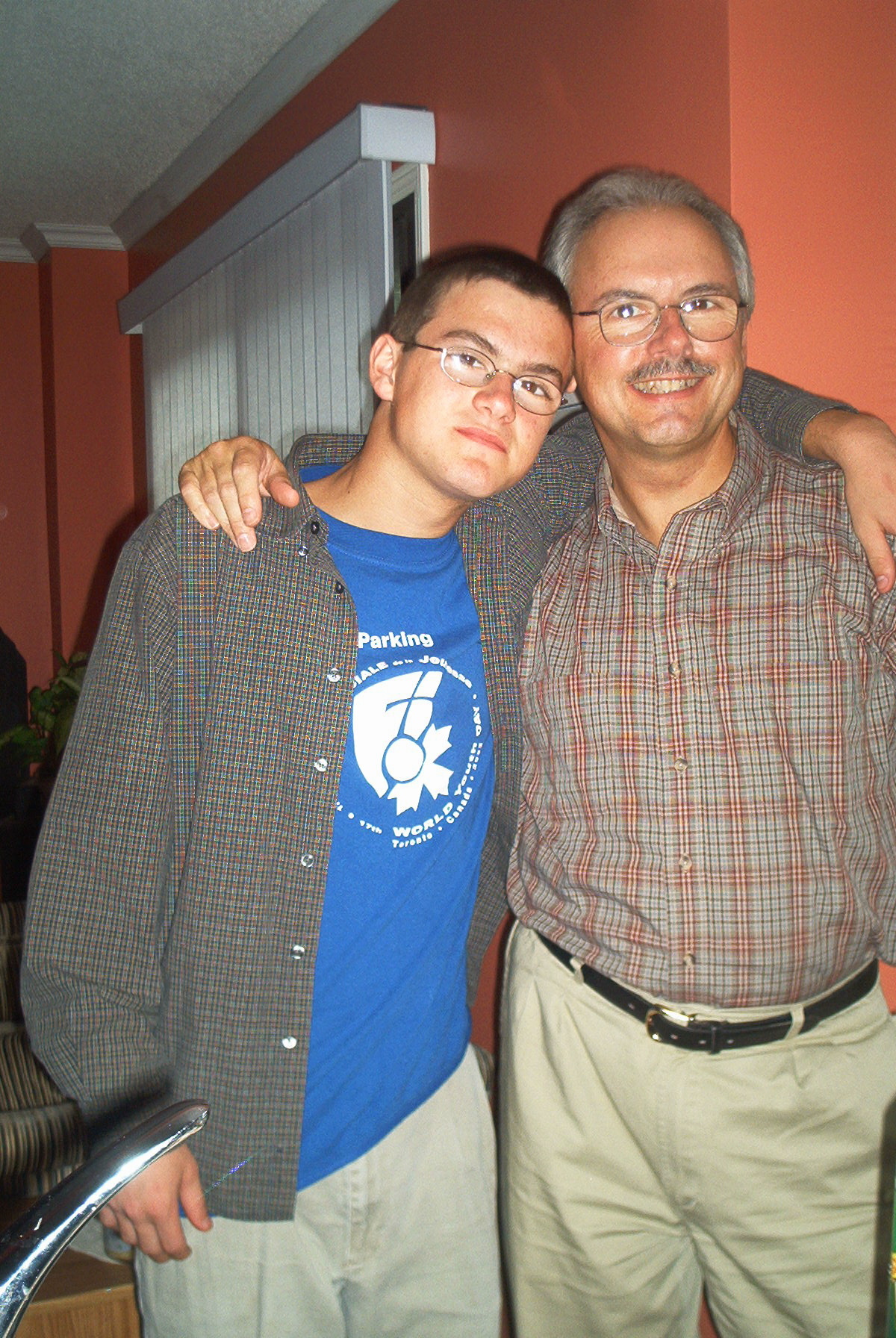 Tom and his father, Peter McKnight, with their arms around each other